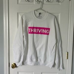 White sweatshirt with bold print.